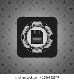 diskette icon inside black emblem