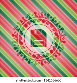 diskette icon inside christmas colors badge.