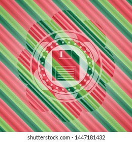 diskette icon inside christmas colors badge.