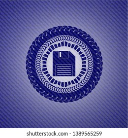 diskette icon inside emblem with jean background