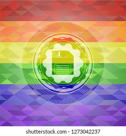 diskette icon inside emblem on mosaic background with the colors of the LGBT flag