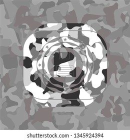 diskette icon inside grey camouflage emblem