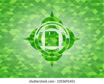 diskette icon inside realistic green emblem. Mosaic background