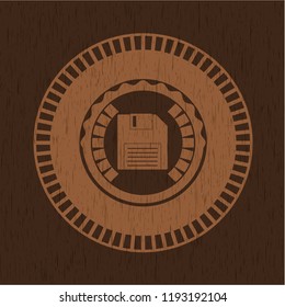 diskette icon inside realistic wood emblem