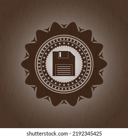 diskette icon inside retro style wood emblem. 