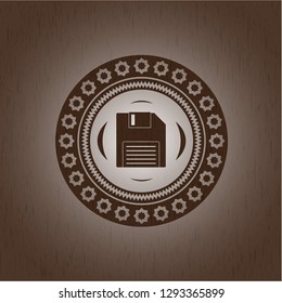 diskette icon inside retro wood emblem