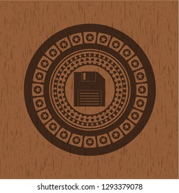 diskette icon inside retro wood emblem