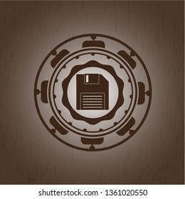 diskette icon inside retro wood emblem