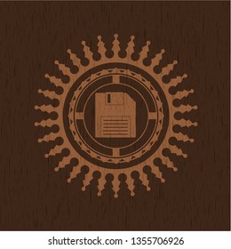 diskette icon inside vintage wood emblem