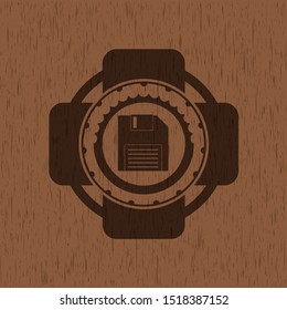 diskette icon inside vintage wooden emblem