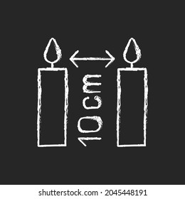Distance between burning candles chalk white manual label icon on dark background. Place three inches apart. Fire safety. Isolated vector chalkboard illustration for product use instructions on black
