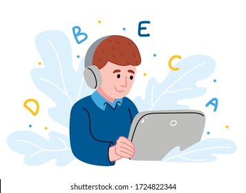 Distance learning online education. Schoolboy studying at home with digital tablet.Home school education Concept.Child study online sitting with tablet and headphones. Child listening to teacher.