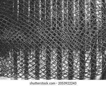 Distress vector texture of metal spring and fishing net on top of it. Black and white grunge background. EPS8 illustration.