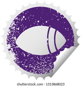 distressed circular peeling sticker symbol of a eye looking to one side
