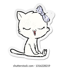 distressed sticker of a cartoon cat with bow on head