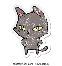distressed sticker of a cartoon cat with bright eyes