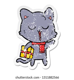 distressed sticker of a cartoon cat with gift