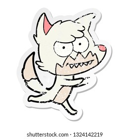 distressed sticker of a cartoon grinning fox