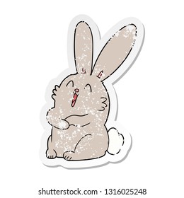 distressed sticker of a cartoon laughing bunny rabbit