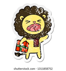 distressed sticker of a cartoon lion with christmas present