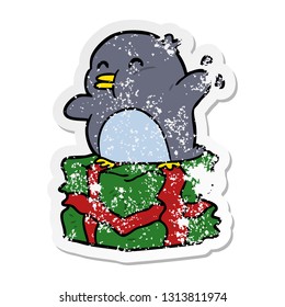distressed sticker of a cartoon penguin on present