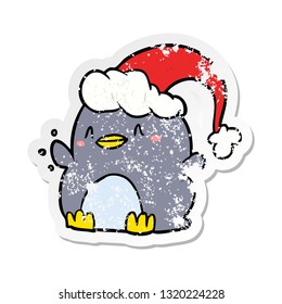 distressed sticker of a cartoon penguin wearing christmas hat
