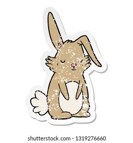 distressed sticker of a cartoon sleepy rabbit