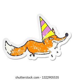 distressed sticker of a cartoon sly fox in party hat