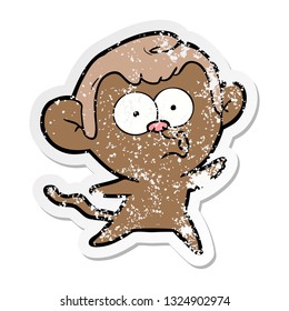 distressed sticker of a cartoon surprised monkey