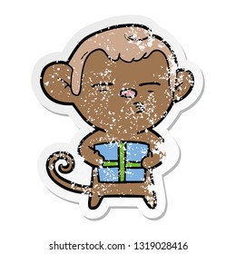 distressed sticker of a cartoon suspicious monkey with present
