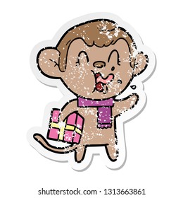 distressed sticker of a crazy cartoon monkey with christmas present