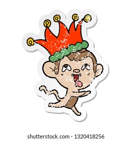 distressed sticker of a crazy cartoon monkey wearing jester hat