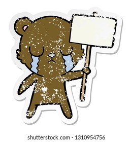 distressed sticker of a crying cartoon bear with sign