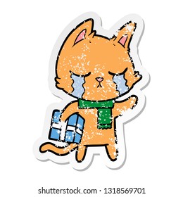distressed sticker of a crying cartoon cat holding christmas present