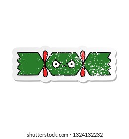 distressed sticker of a cute cartoon christmas cracker