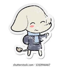 distressed sticker of a cute cartoon elephant in winter clothes