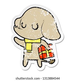 distressed sticker of a cute cartoon elephant with gift