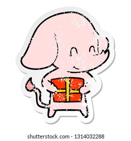 distressed sticker of a cute cartoon elephant with present