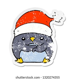 distressed sticker of a cute cartoon penguin wearing christmas hat