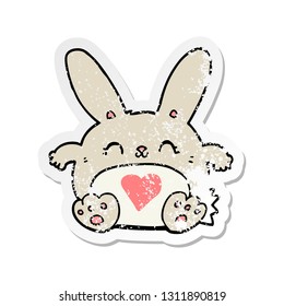 distressed sticker of a cute cartoon rabbit with love heart