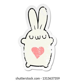 distressed sticker of a cute cartoon rabbit with love heart