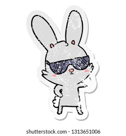 distressed sticker of a cute cartoon rabbit wearing sunglasses