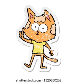 distressed sticker of a happy cartoon cat giving peace sign