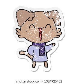 distressed sticker of a happy little cartoon dog in winter clothes