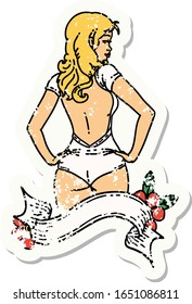 distressed sticker tattoo in traditional style of a pinup swimsuit girl with banner