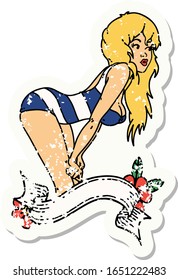 distressed sticker tattoo in traditional style of a pinup girl in swimming costume with banner