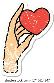 distressed sticker tattoo in traditional style of a hand holding a heart