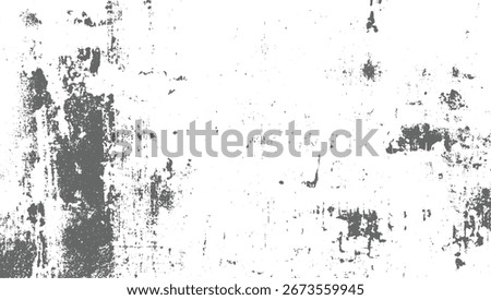A distressed textured background with gray patches and speckles on a white surface.