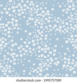 Ditsies floral pattern. Pretty flowers on light blue background. Printing with small white flowers. Ditsy print. Seamless vector texture. Spring bouquet.