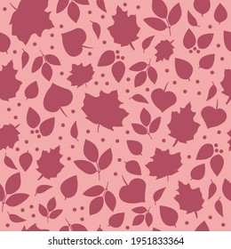 Ditsy autumn leaves seamless vector pattern texture, with dark rose elements on a light blush pink background. Girly, cute, feminine fall season design with small scale leaf silhouette illustrations.